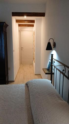 a bedroom with a bed and a hallway with a door at Monte Longu in Baunei