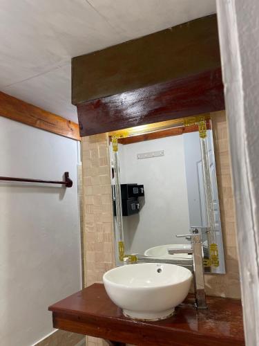 a bathroom with a white sink and a mirror at Playa Paraiso en Magante in La Yagua