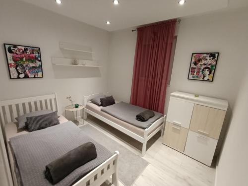 a small room with two beds and a window at Lux Old Bridge in Mostar