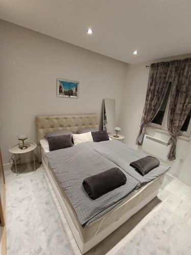 a bedroom with a large bed with two pillows on it at Lux Old Bridge in Mostar