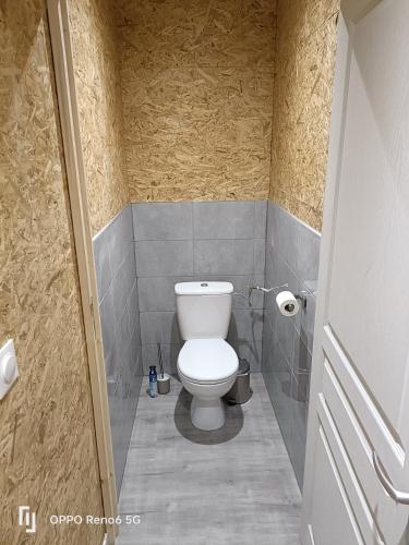 a bathroom with a white toilet in a stall at MA Loc in Aubin