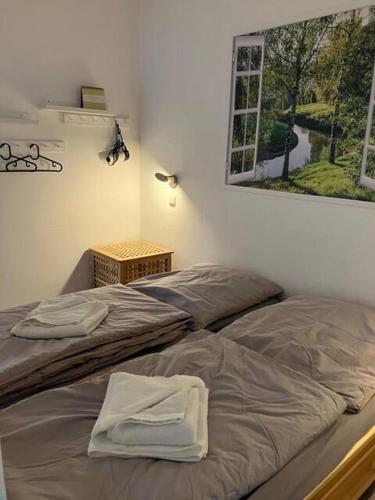a bed with two towels on it in a room at Oben in der 14 Etage in Braunlage
