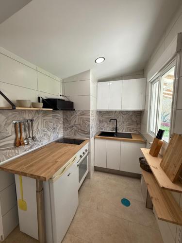 a kitchen with white cabinets and a sink at Camping Armalygal in Murillo de Gállego