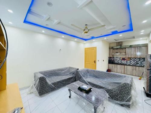 a room with a bed covered in plastic at Executive Oasis in Mūsapur