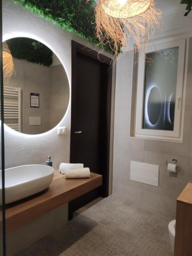 a bathroom with a sink and a mirror at Suite Maison Tropical 2 - Apulian Experience in Noicattaro