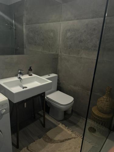 a bathroom with a sink and a toilet at Apartament Lux Nowe Ogrody 2 Poznań 24 H Lotnisko Airport in Poznań