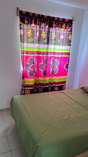 a bed in a room with a curtain with the word ego at Peace and quiet in Guadalupe