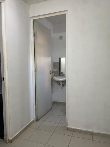 an open door to a bathroom with a sink at Peace and quiet in Guadalupe