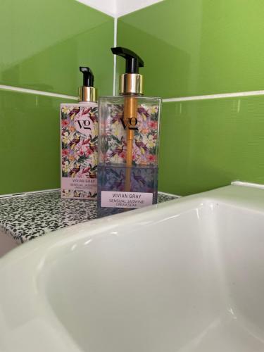 two bottles ofodorizers sitting on a bathroom counter at The Dairy Flat in Cheddar
