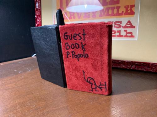 a red book sitting on top of a table at Pensione Popolo in Montréal