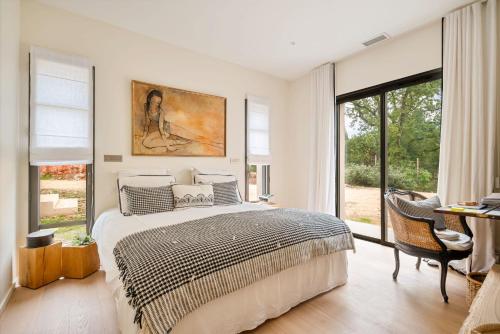 une chambre avec un lit et une grande fenêtre dans l'établissement Maison Cézanne, au Tholonet