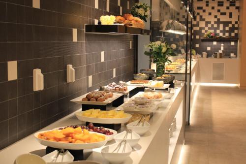 a buffet line with many different types of food at Arirang Hill Hotel Dongdaemun in Seoul