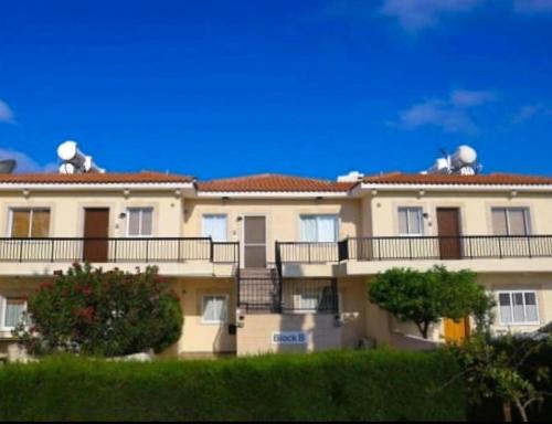 a large building with balconies on the side of it at Sunset Green 01 in Paphos City