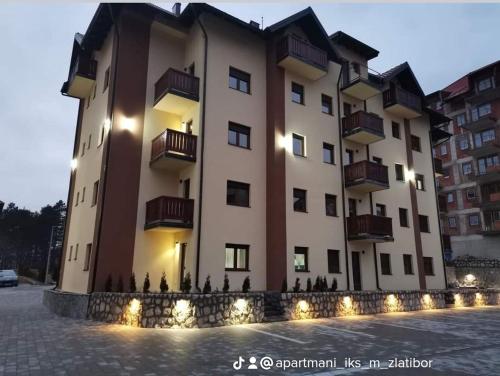 a large building with lights in front of it at Apartman IKS-M & Spa in Zlatibor
