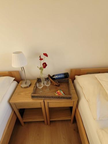 a table with glasses and a lamp on a bed at Adventure house Katrine in Mosvik
