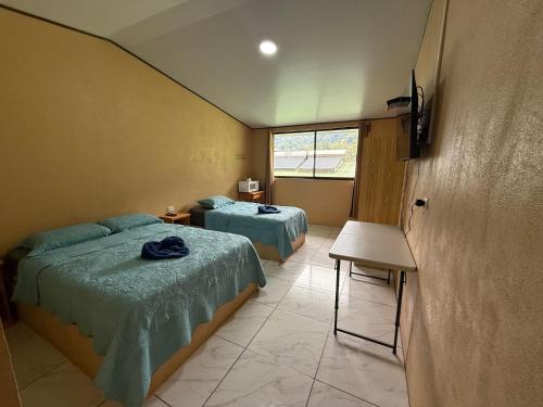 Postel nebo postele na pokoji v ubytování Hotel Uran