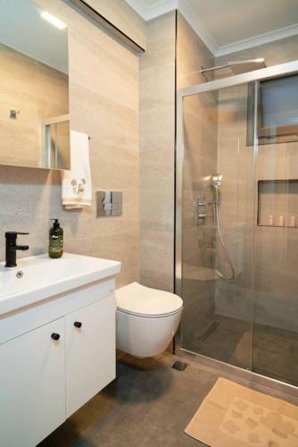 a bathroom with a shower and a toilet and a sink at Mama Saggio Home in Fethiye