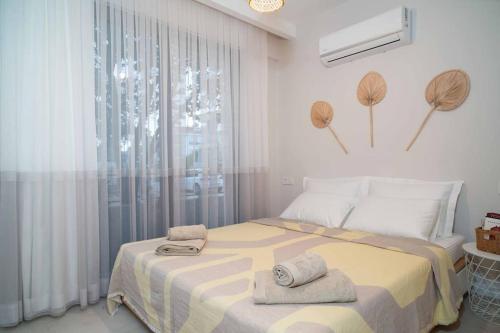 a bedroom with a large bed with towels on it at Mama Saggio Home in Fethiye