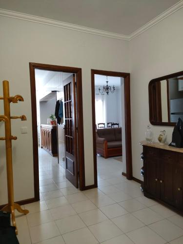 a living room with two doors and a mirror at Apartamento T2 Amorosa Beach in Viana do Castelo
