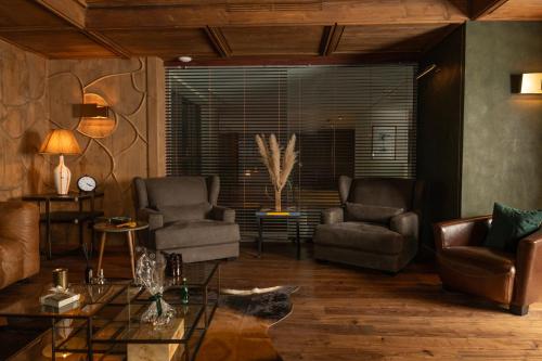 a living room with two chairs and a table at Suites By Le Rêve in Tangier
