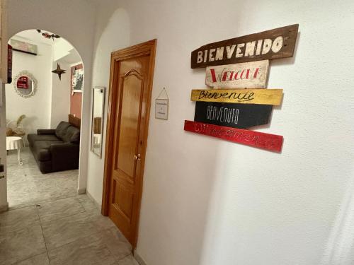 a hallway with signs on the wall of a house at Habitación en Calle Molino in Málaga