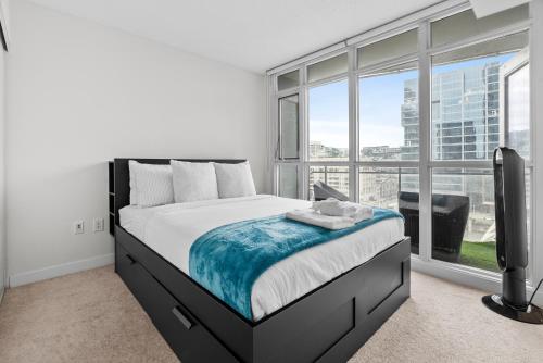 a bedroom with a bed and a large window at Apartment in Downtown Toronto in Toronto