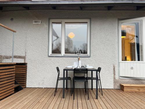 a table and chairs on a patio with a window at Cozy Independent House with Free Parking and 20 mins to center in Helsinki