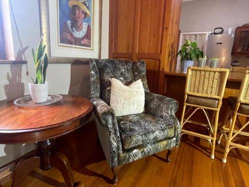 a living room with a chair and a table at 15 On Le Roux in Robertson