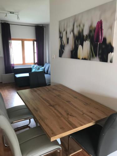 a living room with a wooden table and chairs at Tulipános Ház in Badacsonytomaj
