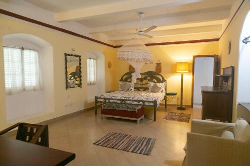 a living room with a bed and a couch at Zanzibar Vintage House in Stone Town