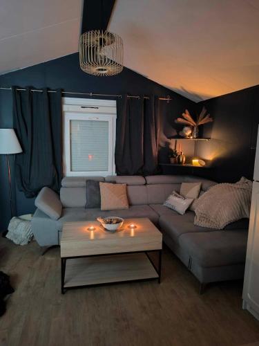 a living room with a couch and a table at Mobilhome Metanova in Camiers