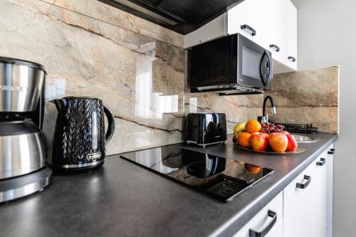 a kitchen with a counter top with fruit on it at Top Alex domki Międzyzdroje Lubin in Międzyzdroje