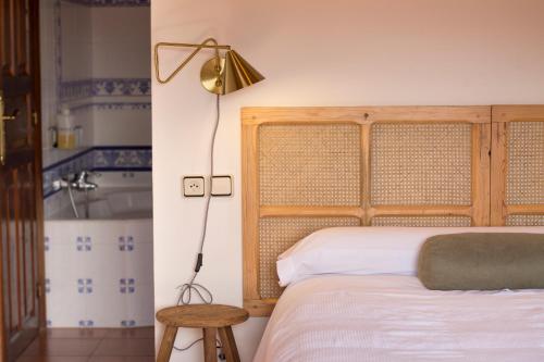 a bedroom with a bed and a lamp and a tub at El Patio de la Morera I in El Rasillo