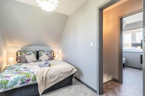 a bedroom with a bed and a large mirror at Top Alex domki Międzyzdroje Lubin in Międzyzdroje