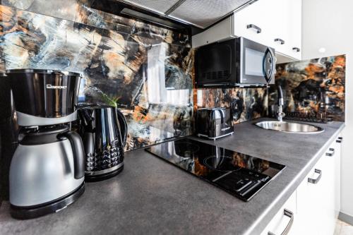 a kitchen with a coffee maker on a counter at Top Alex domki Międzyzdroje Lubin in Międzyzdroje