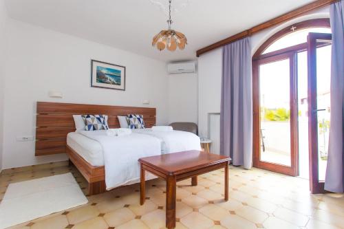 a bedroom with a large bed and a table at Villa Purić in Rovinj