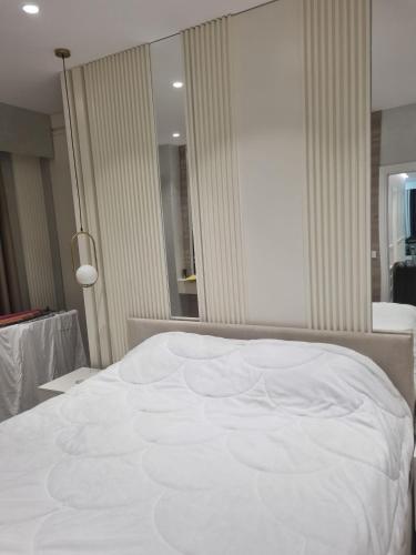 a large white bed in a room with a window at Kodra e diellit residence 2 in Selitë e Vogël
