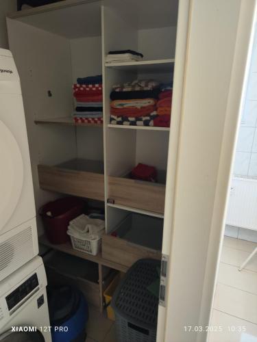 a closet with wooden shelves in a room at Work and Stay Plettenberg 6 Betten Küche Bad in Plettenberg