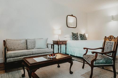 a living room with a couch and a table at The Kent Motel in Niagara on the Lake