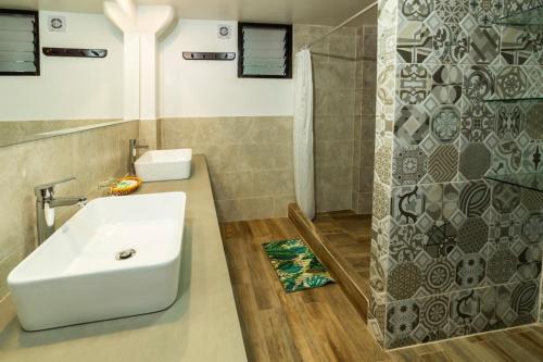 a bathroom with a white sink and a shower at Gringo Bill's Boutique Hotel in Machu Picchu