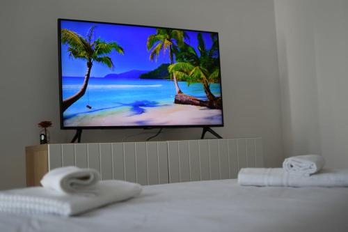 a flat screen tv sitting on top of a bed at Canyon House Leuca in Leuca