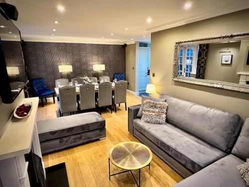 a living room with a couch and a dining room at Honey Hill Cottage - 4 Bedroom Detached House in Cambridge