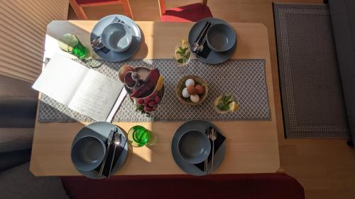 a table with plates and dishes on top of it at Ferienwohnung Manuela in Adnet