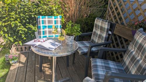 a table and chairs on a patio with wine glasses at Ferienwohnung Manuela in Adnet