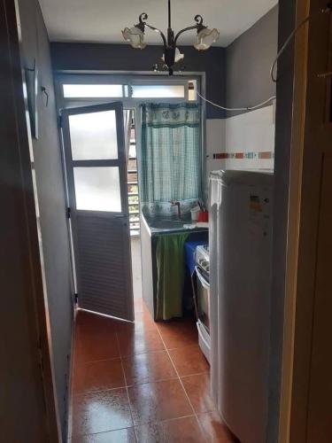 a kitchen with a refrigerator and a table in it at Monoambiente NONA in Villa Cura Brochero