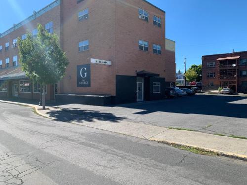 an empty street in front of a brick building at Modern Unit 313 at The George in Klamath Falls