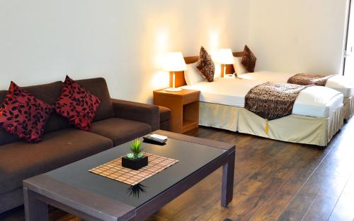 a living room with a couch and a bed at Nata Beach Villa in Ishigaki Island