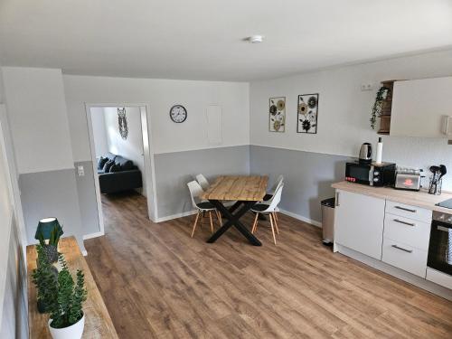 a kitchen and living room with a table and chairs at Fewo Kirch Jesar in Kirch Jesar