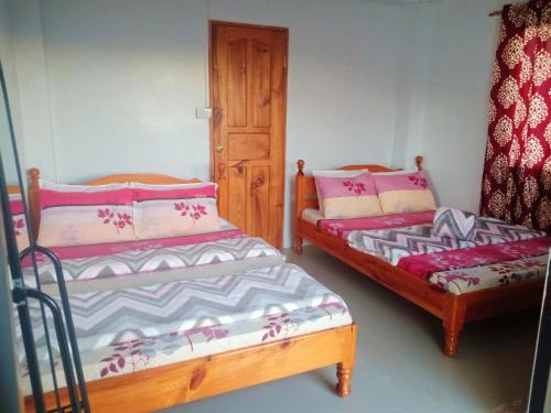 a room with two beds and a couch in it at FAMILY UNIT in SAGADA in Sagada