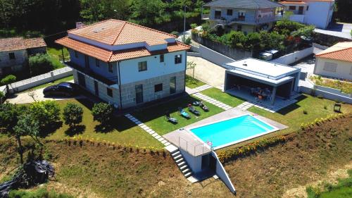 an aerial view of a house with a swimming pool at Varandas do Castelo in Celorico de Basto